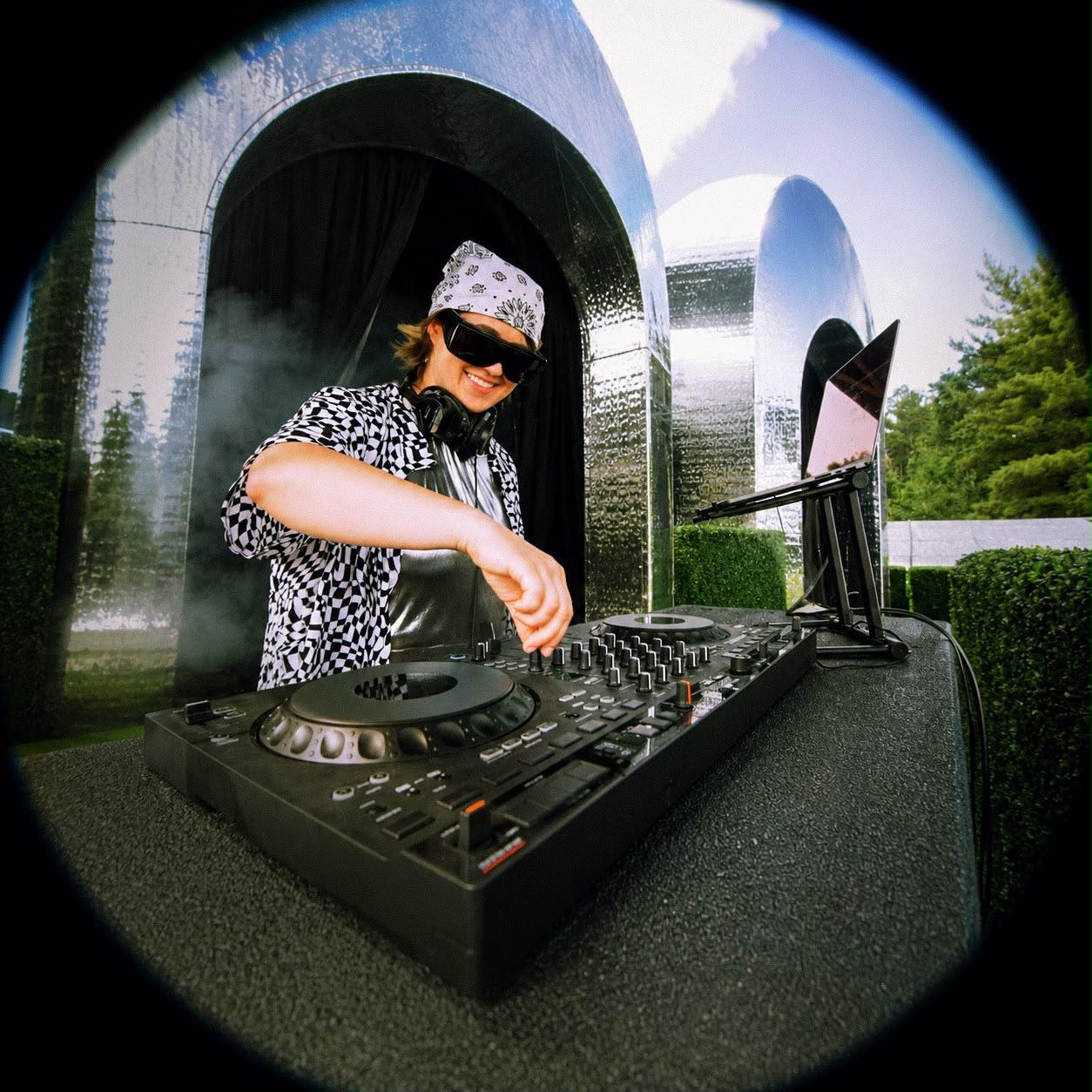 Grace Pisula DJing ecstatic dance at Electric Forest 2026, mirrored arches behind her