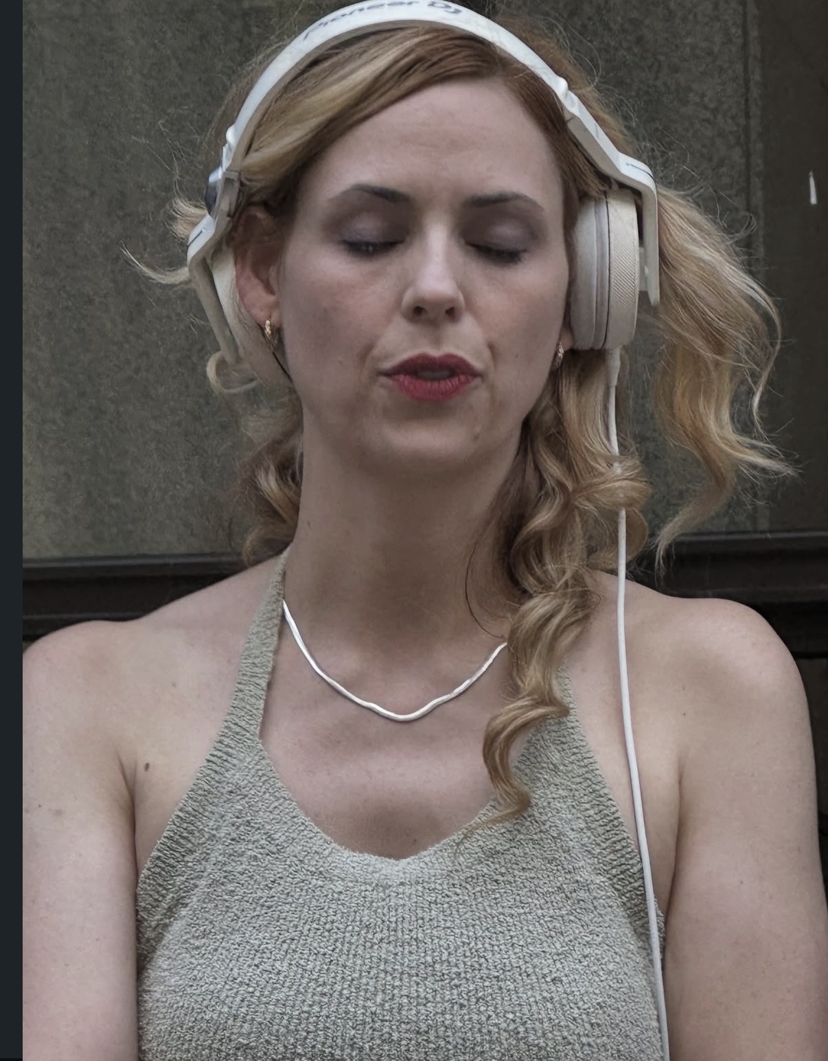 DJ Supernatural with headphones on, eyes closed, lost in the music